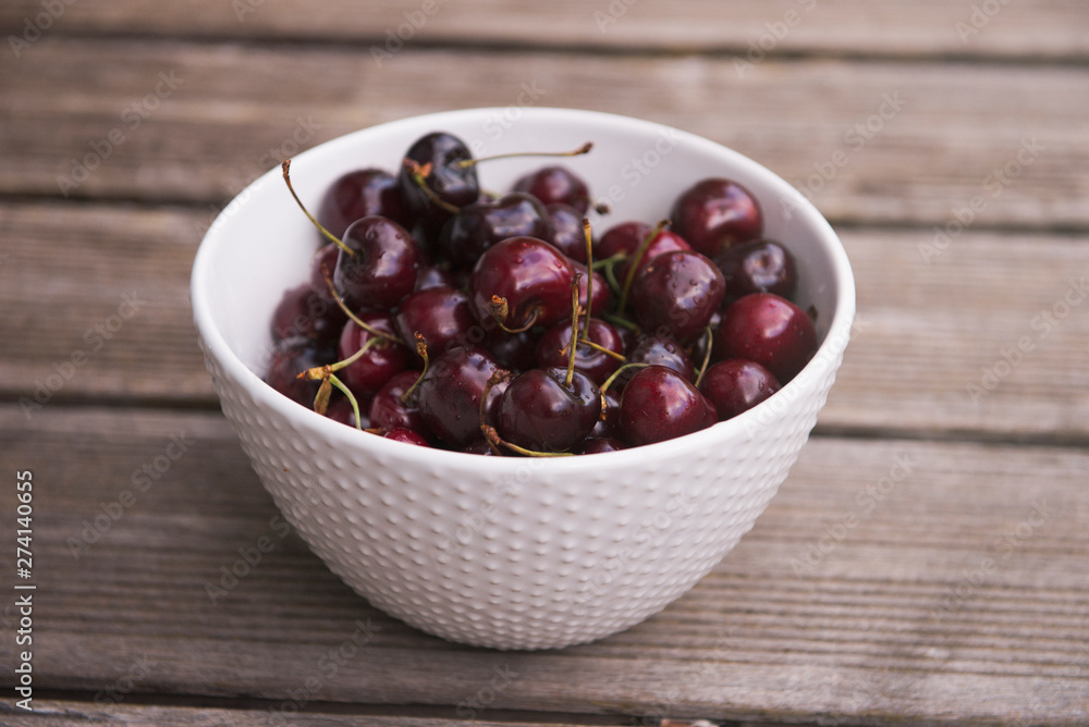Fresh cherry on plate on wooden blue background. fresh ripe cherries. sweet cherries. Fresh cherry on plate on wooden blue background. fresh ripe cherries. sweet cherries.