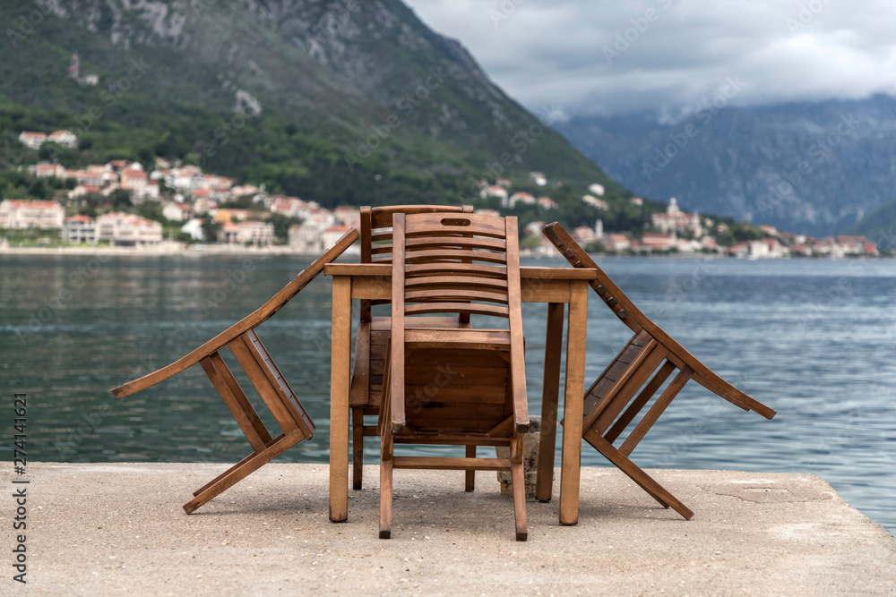 Table and chairs on the seaside terrace after spring rain Table and chairs on the seaside terrace after spring rain