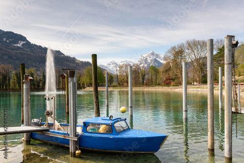 Canvas Print Fishing motor boat moored on Walensee lake on a sunny spring day