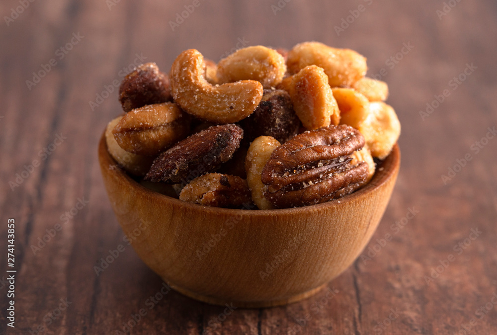 Honey Roasted Nuts on a Rustic Dark Wood Table Honey Roasted Nuts on a Rustic Dark Wood Table