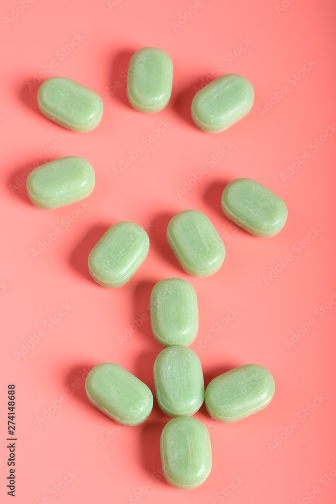 mint candy on a pink background. candy from a sore throat and cough mint candy on a pink background. candy from a sore throat and cough