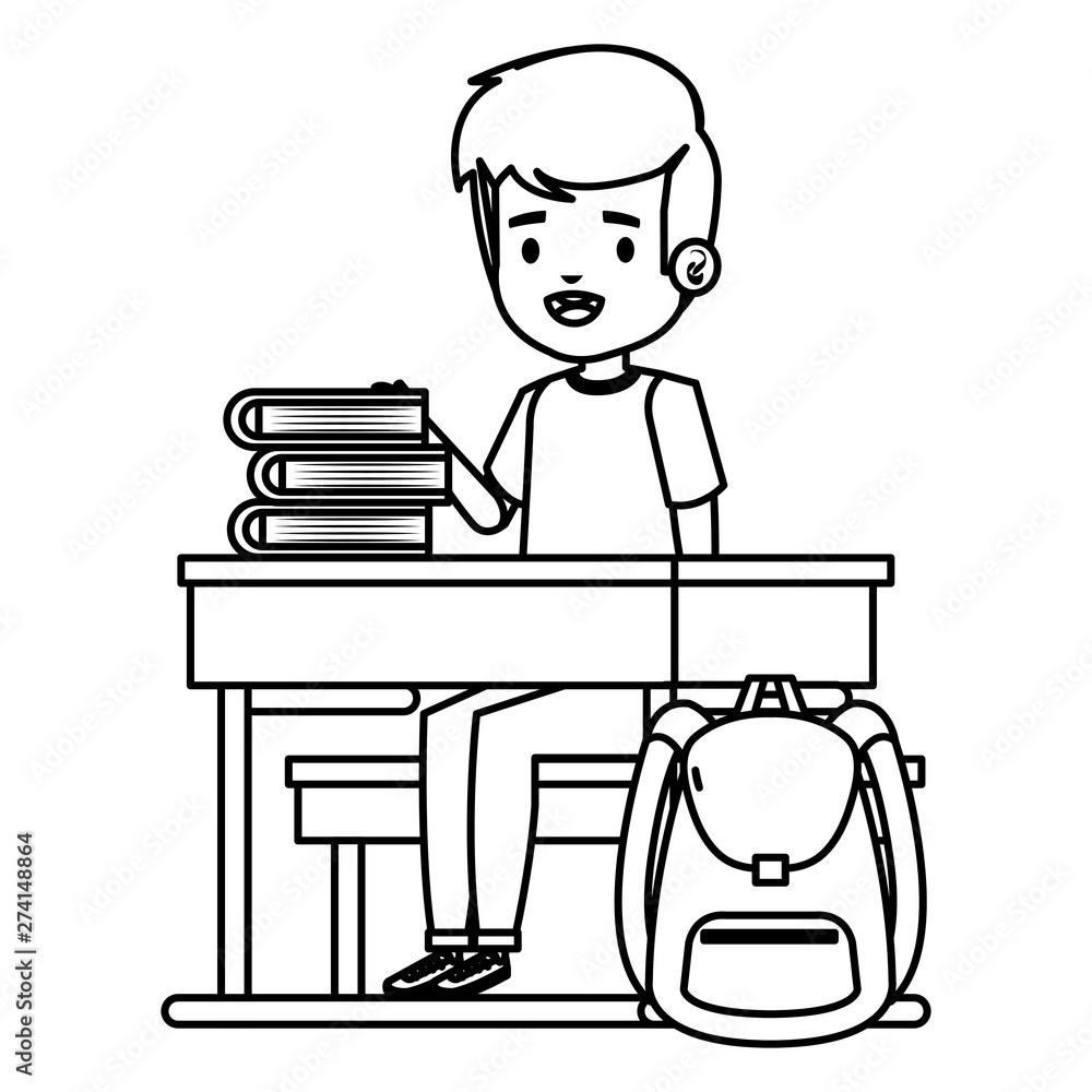 student boy seated in school desk with books and bag