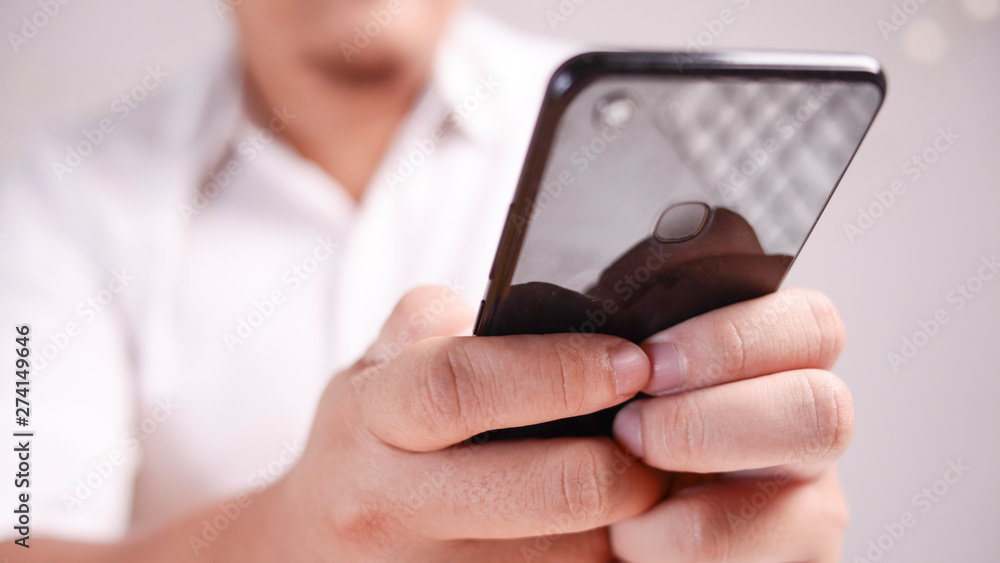 Businessman Holding and Using Smart Phone Businessman Holding and Using Smart Phone