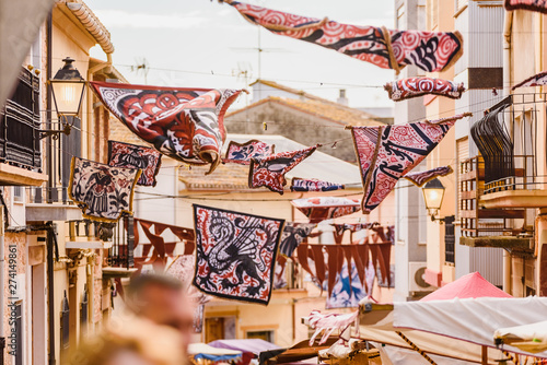 Valencia, Spain - January 27, 2019: Medieval banners hanging between streets at an open-air festival.