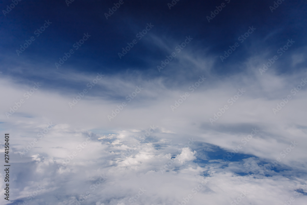 Plane window view with blue sky and beautiful clouds. As seen through window of an aircraft. View of wing & ocean. Airplane from city Bangkok to island Bali. Plane window view with blue sky and beautiful clouds. As seen through window of an aircraft. View of wing & ocean. Airplane from city Bangkok to island Bali.