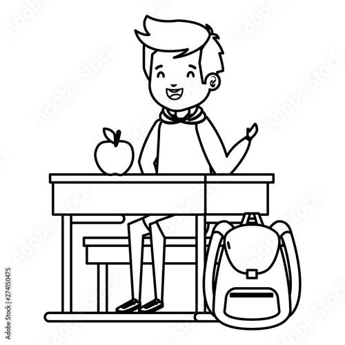 student boy seated in school desk with apple and bag