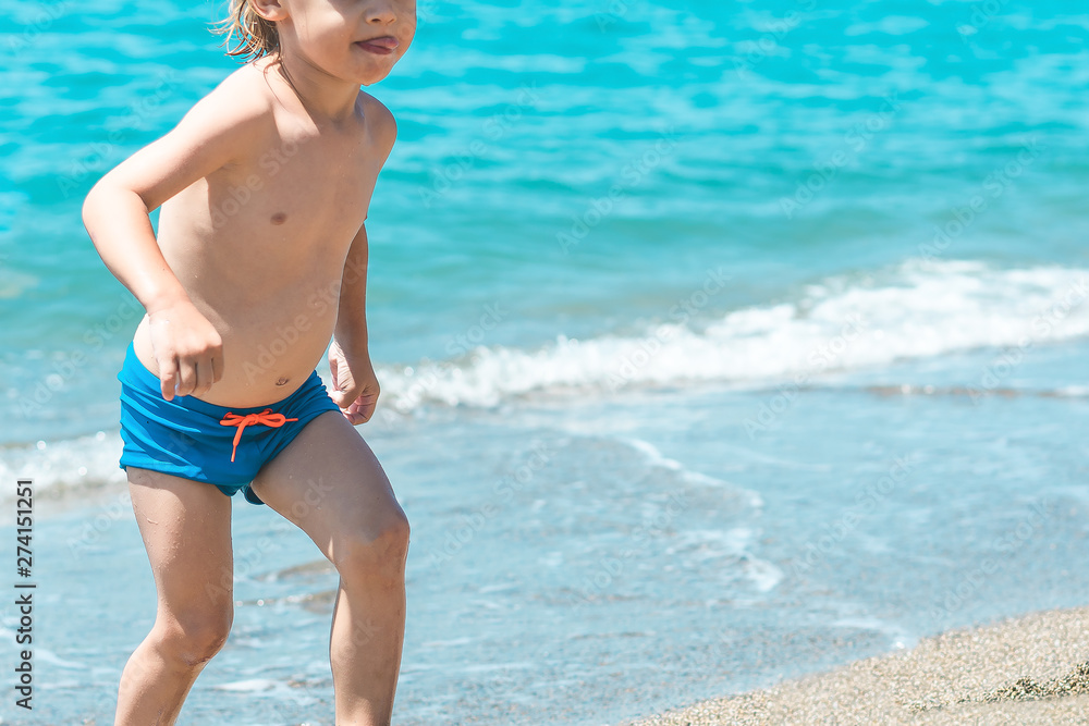 Adorable little blond kid boy having fun on tropical beach Adorable little blond kid boy having fun on tropical beach