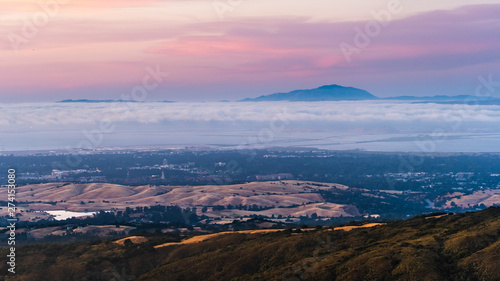 Clouds and fog at twilight over Silicon Valley and the San Francisco bay area; Stanford University visible under a layer of clouds; Mt Diablo in the background;