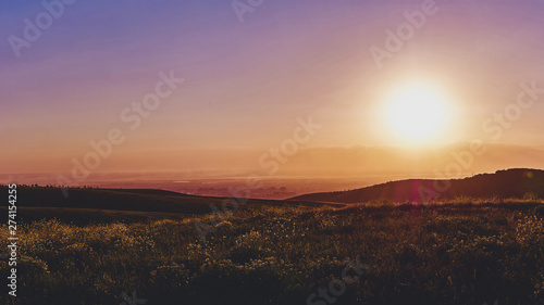 Panorama of a mountain valley in the summer. Fabulous sunset in the mountains, amazing nature, summer in the mountains. Travel and camping, tourism