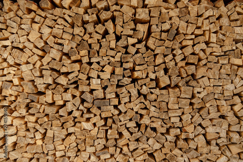 The texture of wooden firewood, randomly split and laid in straight rows