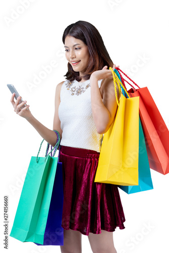 Happy woman in summer enjoying shopping holding smartphone and colorful shopping bag on white background, shopping concept, isolate concept.