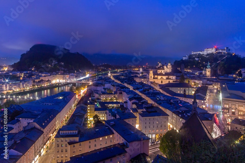 Beautiful view of Salzburg skyline with Festung Hohensalzburg and Salzach river at blue hour, Salzburger Land, Austria