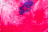 abstract photo of pink paint in water on white background
