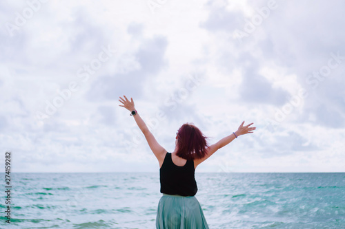 Woman rise hands up to sky freedom concept with blue sky.