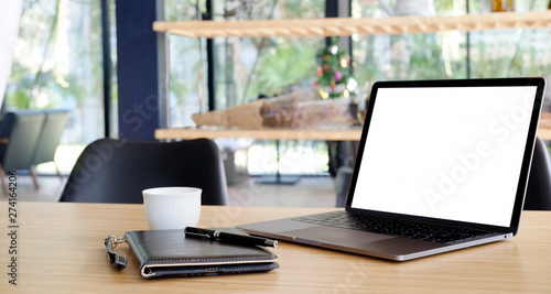 Comfortable workplace with blank screen laptop