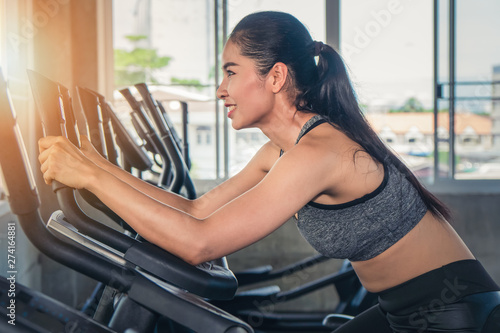 female having exercise with bicycle in gym