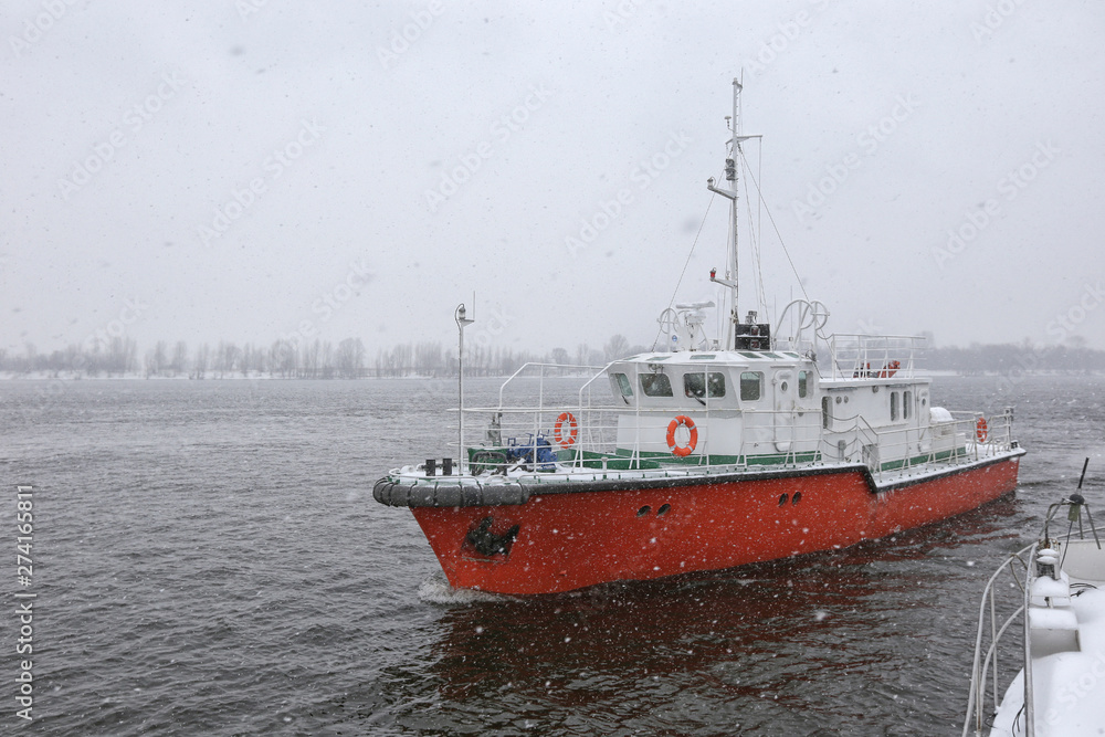 Test the motor boat on the Kama River in the late fall in snowfall Test the motor boat on the Kama River in the late fall in snowfall
