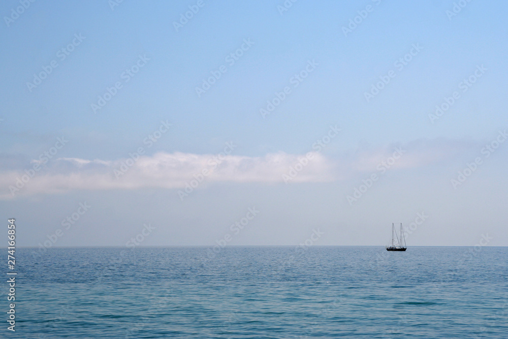 Lonely yacht in the calm blue sea Lonely yacht in the calm blue sea