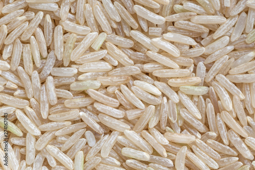close up of uncooked brown rice grains background