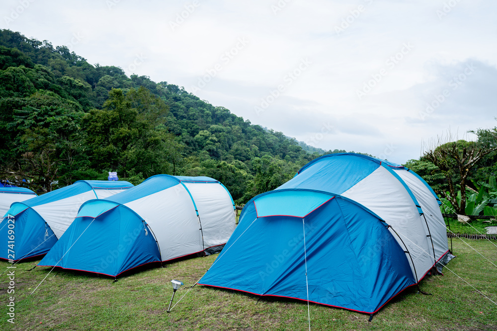 The blue tent was spread on the grassland. In the national park