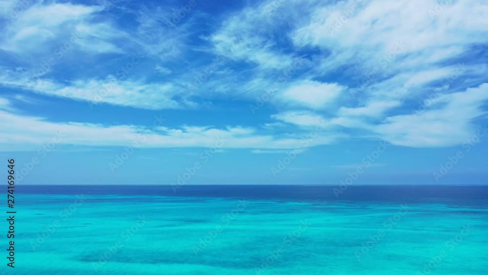 caribbean shot of turquise clean ocean water and big white fluffy clouds in the background caribbean shot of turquise clean ocean water and big white fluffy clouds in the background