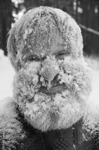 Bearded man in the forest after swimming in the snow