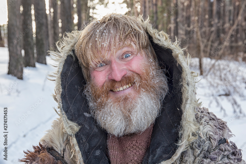 Bearded cheerful man in the winter forest. Bearded cheerful man in the winter forest.