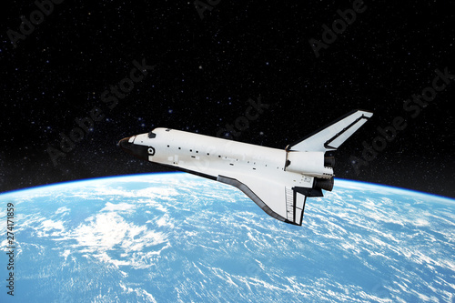 Space shuttle orbiting in  a space over the earth planet and starry background. Elements of this image furnished by NASA.
