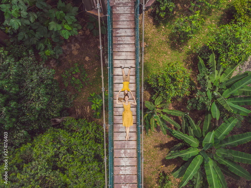 Photography Mom and son tourists at capilano suspension bridge kuala lumpur forest eco-park areial view