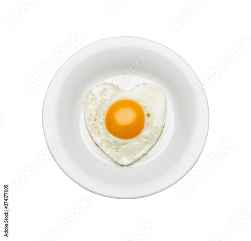 White plate with scrambled eggs in the shape of a heart, isolated on white.