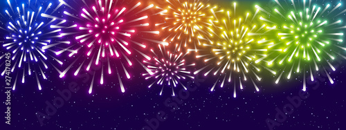 Shiny rainbow fireworks on starry sky background - horizontal panoramic banner for Your holiday design