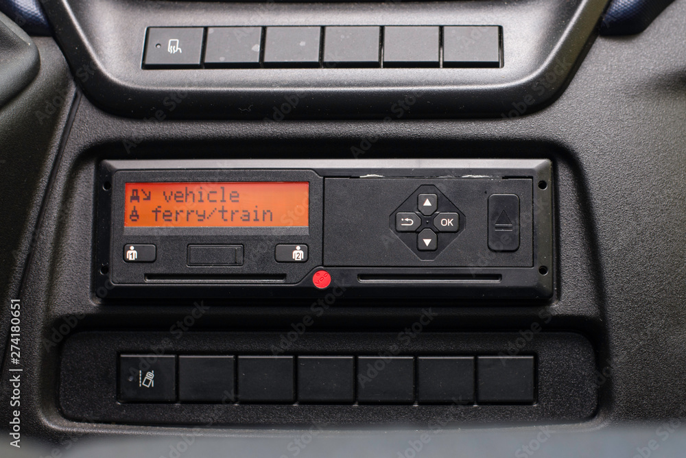 Digital tachograph display reads Vehicle Ferry Train. No personal data. Tachograph in a van Digital tachograph display reads Vehicle Ferry Train. No personal data. Tachograph in a van