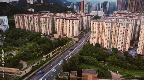 Aerial View Of Hong Kong High-Rise Residential Buildings Mei Foo Sun Chuen And Manhattan Hill And Commercial Buildings In Lai Chi Kok During Sunset. Light Traffic On Highway 5. photo