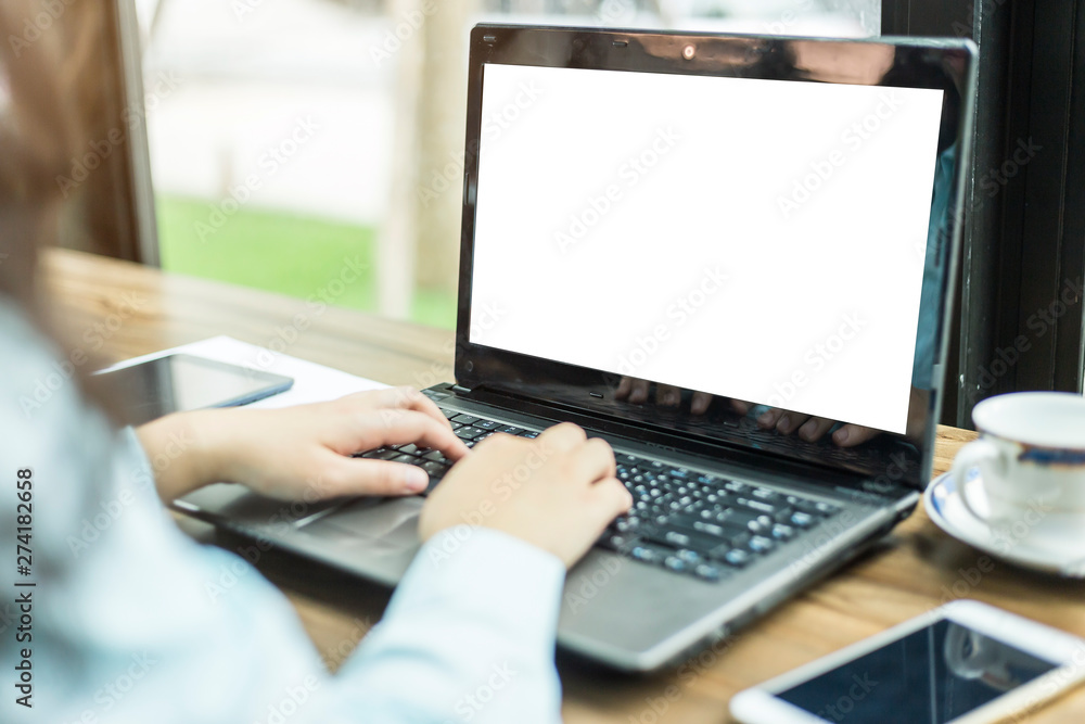 Close-up of business female working with laptop and smartphone in coffee shop like the background Close-up of business female working with laptop and smartphone in coffee shop like the background