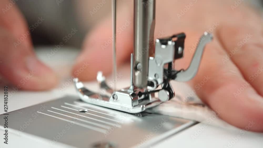 Tailor sewing clothes. Women's hands behind her sewing. Studio video shot of people in the action in 4K definition. Tailor sewing clothes. Women's hands behind her sewing. Studio video shot of people in the action in 4K definition.