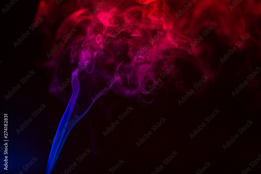 Fototapeta premium Colorful smoke close-up on a black background