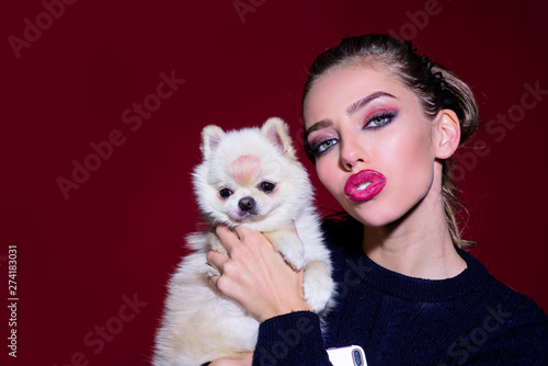 Woman with pomeranian spitz. Dog after grooming. Love to animals. Sensual woman with sweet puppy. Adorable girl with small cute dog. Friendship  love. Woman and dog. Pets concept. Girl hugs little dog