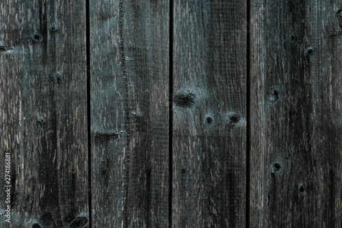 Dark gray green wooden fence. Shabby table, dirty oak, alder tree, pine lumber. Old grey wooden boards. Pattern of wooden surface of green logs. Backgrounds of cracked planks, batten, bar. Strips on b