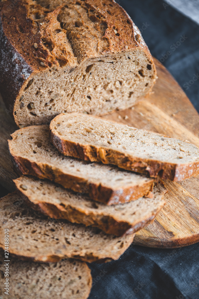 Rye bread with sunflower seeds on a wooden cutting board. Rye bread with sunflower seeds on a wooden cutting board.