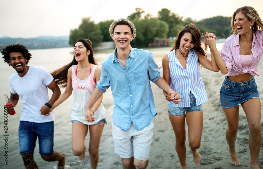 Group of friends having fun on the beach. Summer holidays, vacation and people concept. Group of friends having fun on the beach. Summer holidays, vacation and people concept.