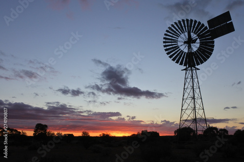 Silhouette of a large windmill in central Australia outback