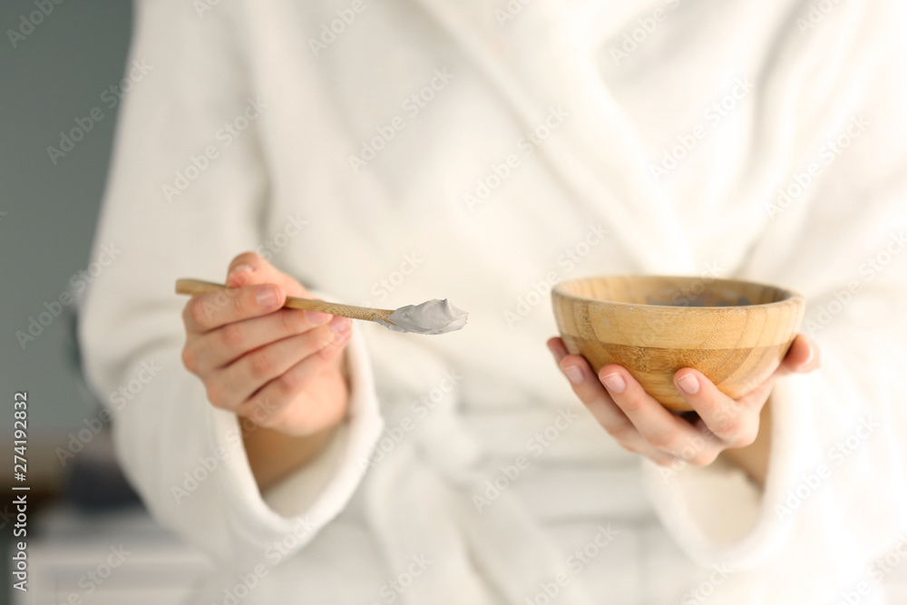 Young woman with bowl of cosmetic clay, closeup Young woman with bowl of cosmetic clay, closeup