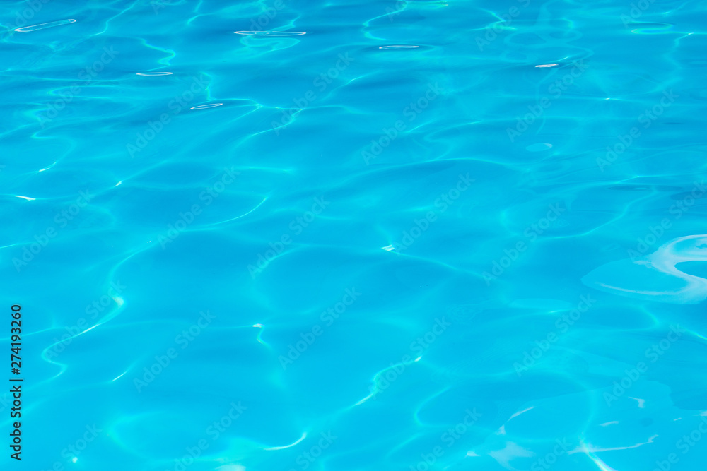 Clear transparent light blue water in the pool. Texture, water background in the pool_