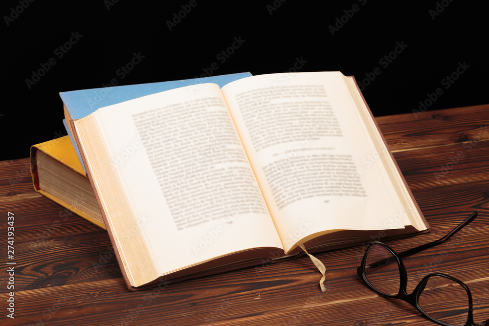 Fototapeta premium Vintage book, open, on old wooden table.