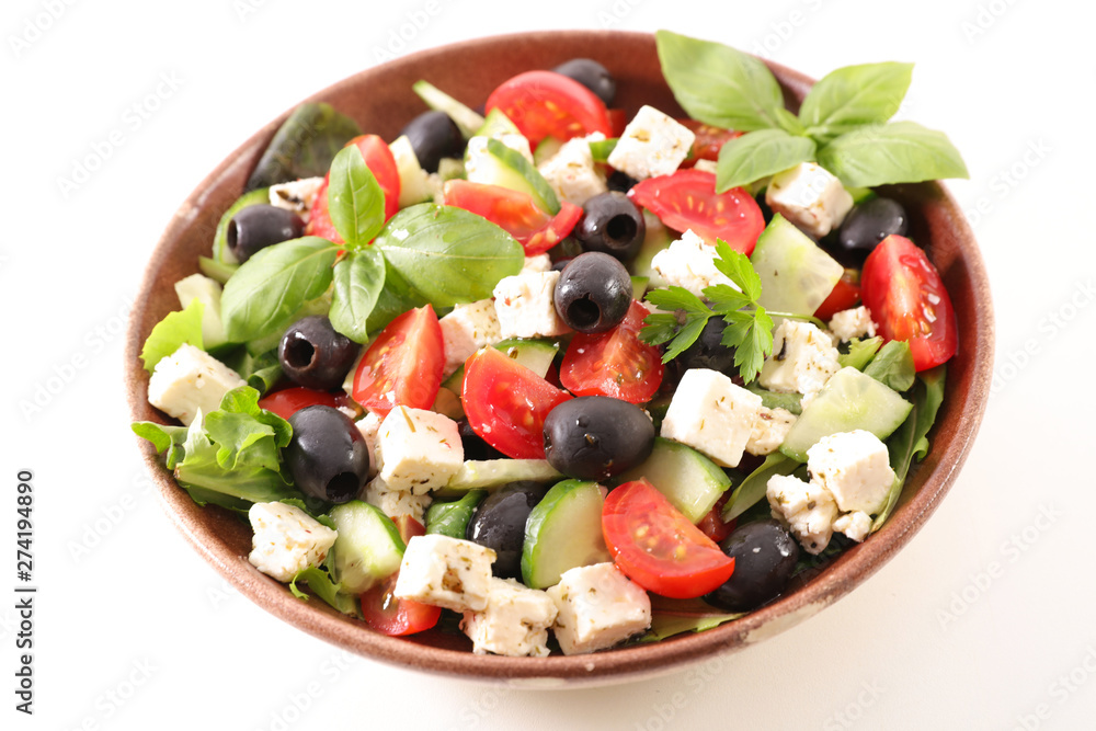 bowl of salad with feta cheese, olive, tomato and basil