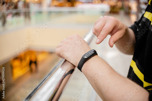 Man is wearing a fitness bracelet. Smart watch on the hand of a man. Pensioner Using Fitness Tracker.