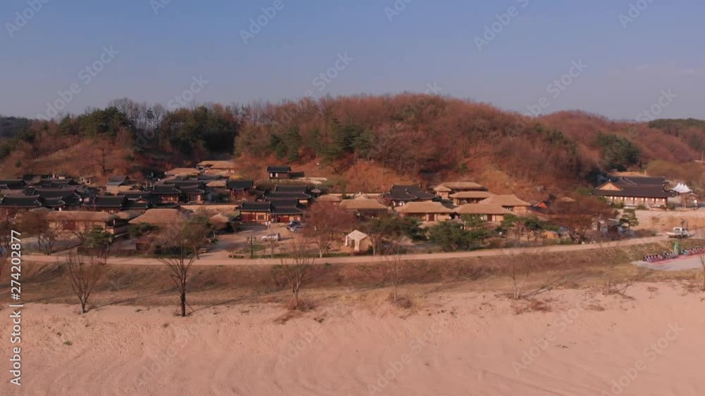 Aerial gentle tilt down rise up in front of Korean traditional village Aerial gentle tilt down rise up in front of Korean traditional village