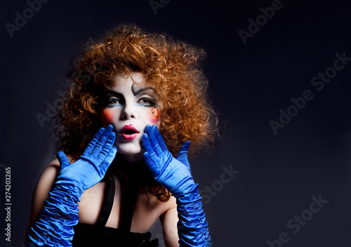 Woman mime with theatrical makeup. Studio shot.