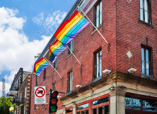 Rainbow gay pride flags waving on the flag pole