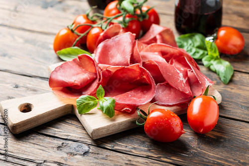 Italian antipasto with bresaola and red wine photo